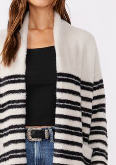 Why snuggle up with a blanket this Fall when you can have our cozy sweater instead? Our classic fuzzy cardigan, detailed with mirrored stripes, features an open front and handy patch pockets—ideal for your on-the-go lifestyle. Whether you’re at home, running errands or working from your favorite coffee shop, this plush cardigan ensures you step out in both comfort and style. Striped Relaxed fit Fuzzy texture Long sleeve Drop shoulder Open front Mid-length Shawl collar Patch pockets Bohemian stat Winter Striped Cardigan For Layering, Trendy Striped Outerwear For Layering, Cozy Striped Winter Outerwear, Oversized Striped Outerwear For Layering, Winter Striped Outerwear For Layering, Striped Outerwear For Winter Layering, Cozy Striped Knit Outerwear, Fuzzy Texture, Stripe Cardigan