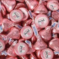 there are many pink heart shaped candies in the bag with price tags on them