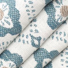 three pieces of fabric with blue and white designs on them, one is folded in half