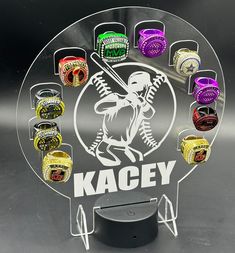 an acrylic display with rings on it and the name kacey written in white