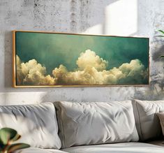 a painting hanging on the wall above a couch