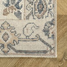 an area rug on top of a wooden floor with a wood floor in the background