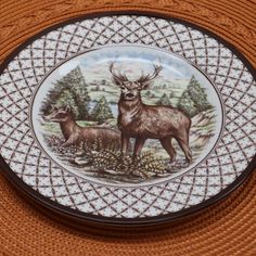 a decorative plate with two deer on it