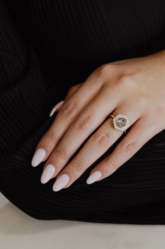 a woman's hand with a ring on it