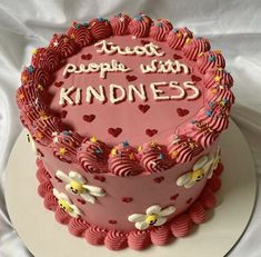 a pink heart shaped cake with writing on it