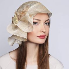 TIMELESS BEAUTY EXUDES AN AURA OF BLISS AROUND YOU Couture Hat with Bow and Brooch Kentucky Derby Wedding Headwear *Sizes: 57cm(22,4 inches); 59cm(23,23 inches) *Handmade; *High-quality sinamay fabric 100% natural Abaca palm fiber; This beautiful women's couture cloche with golden trim&brooch looks amazingly stunning and ideally accessorizes a multitude of your apparel. Whether you choose a classical dress or a modern and stylish outfit for the upcoming event, this cloche will surely bring out the magnetism and charisma you are looking for. Created using high-quality handwoven sinamay fiber which is so lightweight, and breathable.  With an asymmetrical brim. The bow in tone is added for charm.  Grosgrain inside for a better posture. 📌Sinamay is a material that consists of 100% abaca fiber Elegant Cream Bridal Accessories, Cream Bridal Accessories For Formal Occasions, Fitted Cream Bridal Accessories, Elegant Cream Headpieces For Wedding, Elegant Cream Wedding Headpiece, Elegant Beige Wedding Headpieces, Elegant Gold Mini Hats For Formal Events, Elegant Gold Mini Hat For Formal Occasions, Adjustable Bridal Accessories For Formal Occasions