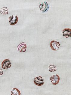 the fabric has many small seashells on it