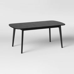 a black table sitting on top of a white floor