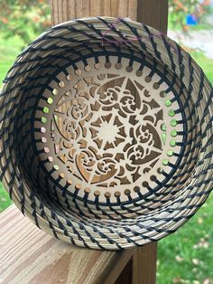 a decorative bowl sitting on top of a wooden table