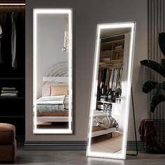 a large mirror sitting on top of a floor next to a bed