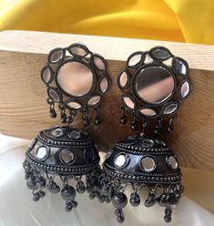 Add a touch of timeless elegance to your jewelry collection with our stunning Oxidized Jhumkis. Perfect for any occasion, these traditional Indian earrings combine intricate craftsmanship with a modern flair, making them a versatile accessory for women of all ages. Features: High-Quality Materials: Made from premium oxidized metal, offering durability and a vintage charm that never goes out of style. Intricate Design: Each pair features exquisite detailing with traditional motifs, capturing the Festive Oxidized Finish Jhumkas For Celebration, Fusion Style Jhumkas With Latkans For Gift, Oxidized Jhumkas For Festivals And Gifts, Gift Oxidized Finish Jhumkas For Festivals, Bollywood Oxidized Finish Jhumkas For Wedding, Fusion Style Oxidized Jhumkas For Diwali, Diwali Fusion Oxidized Jhumkas, Bollywood Style Round Jhumkas With Oxidized Finish, Fusion Style Round Jhumkas For Festivals