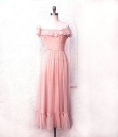 Dreamy pale pink silk organza gown from the 40s with ruffles at the yoke and hem. The skirt is gathered to the natural waist and has ruffles down the back. It is fully lined and has a side metal zipper. Beautiful bride or bridesmaid dress. X Small size it was tight on the size 4 dress form. Measurements with room for comfort: Bust up to: 32 inches. Waist up to: 23 inches. Hips up to: 40 inches. Exact measurements taken flat to compare to a garment which fits well: Length: 53 inches. Length shoul Pink Feminine Bridesmaid Dress For Wedding, Feminine Pink Bridesmaid Dress For Wedding, Vintage Summer Wedding Evening Dress, Vintage Pink Evening Dress For Wedding, 40s Wedding Dress, 40s Wedding Dresses, 40s Wedding, Empire Waist Gown, Organza Gown