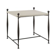 a white table with two black legs and a square top on an iron frame base