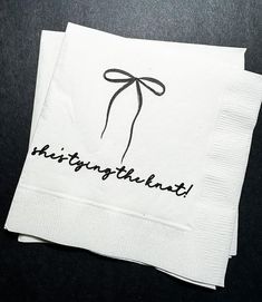 two white napkins with black writing and a bow on the front one says, hingwithland