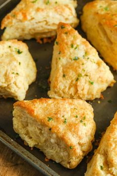 some biscuits are sitting on a baking pan and ready to be baked in the oven