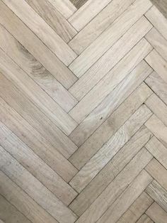 an image of wood flooring that looks like herringbones