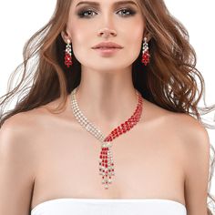 This exquisite set, draped in radiant yellow gold, exudes a timeless charm, while the sparkling Diamondeau®, flawless simulated diamond, adds a touch of sophistication and glamour. At the heart of this ensemble is a necklace that elegantly flows around the neck, reminiscent of a graceful tie, yet imbued with a sense of femininity and grace. The red and white gems create a mesmerizing contrast that captivates the eye and commands attention. Completing the set are the matching earrings. Each earri White Diamond Necklace For Evening, Fine Jewelry, White Diamond Necklace For Evening, Glamorous Diamond Evening Jewelry Sets, Glamorous Evening Diamond Jewelry Sets, Evening Fine Jewelry Crystal Diamond Necklace, Evening Fine Jewelry Crystal Necklace, Fine Jewelry White Bridal Necklace For Party, Evening Crystal Diamond Necklace In Fine Jewelry Style, White Brilliant Cut Jewelry For Evening