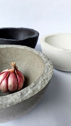 two bowls and one bowl with an onion in it