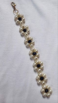 a necklace with pearls and black stones on it