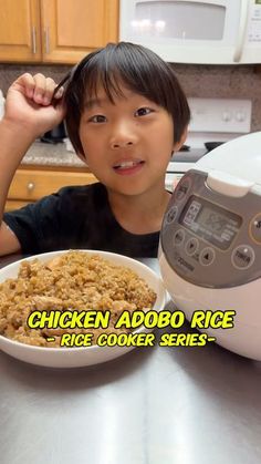 a young boy sitting in front of a bowl of food