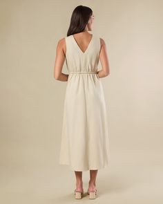 Lightweight and floaty in our summer-weight linen blend, this button-down midi dress is designed with a v-neck bodice featuring pintucked pleats and a cinched-in stretch waist. Pintuck pleat detail on bodice Encased elastic at waist Functional buttons at bodice only V-neckline Midi length Flowy skirt 60% Tencel 20% Linen 20% Cotton Machine wash with like colors. Do not bleach. Hang to dry. Iron warm. Summer Midi V-neck Dress With Tie Waist, Solid V-neck Midi Dress With Smocked Back, Vacation V-neck Pleated Midi Dress, V-neck Midi Dress With Gathered Waist For Day Out, Elegant V-neck Midi Dress With Elastic Waistband, Summer Midi Dress With Surplice Neckline For Daywear, Pleated V-neck Midi Dress For Vacation, V-neck Pleated Midi Dress For Vacation, Summer Rayon Midi Dress With Surplice Neckline