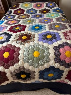 a bed with a colorful quilt on top of it