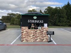 a starbucks coffee stand in a parking lot