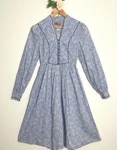 Vintage 1970's Origin dress, made with Liberty of London fabric. Beautiful floral print dress, 100% cotton and in excellent condition. Measurements to follow: Pit to pit 18ins Waist laid flat: 15ins Shoulder to hem: 44ins Always refer to measurements before purchasing. #LibertyDress #Prairie #LibertyPrint #BlueFloralDress #BlueDress Blue Cotton Prairie Dress For Summer, Cotton Vintage Dress With Vintage Print For Daywear, Cotton Vintage Print Dress For Daywear, Light Blue Floral Print Cotton Dress, Light Blue Floral Cotton Dress, Vintage Cotton Dress With Ditsy Floral Print, Vintage Cotton Dresses With Ditsy Floral Print, Cotton Vintage Pattern Dress For Daywear, Blue Fitted Prairie Dress For Spring