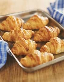 some croissants are on a metal tray