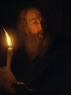 an old man holding a lit candle in his right hand and looking at the viewer