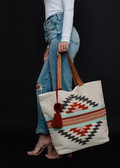 We've got your new go-to tote for the spring and summer season! This beige, brown, red and light blue Aztec inspired tote bag is selling fast, so grab yours soon! Bohemian Bags With Leather Handles For Spring, Bohemian Canvas Bag For Everyday Spring Use, Bohemian Everyday Tote Bag, Bohemian Cream Shopping Bag, Everyday Bohemian Tote Canvas Bag, Bohemian Canvas Hobo Tote Bag, Bohemian Canvas Tote Hobo Bag, Bohemian Tote Bag For Shopping, Spring Canvas Tote Bag With Leather Handles