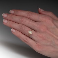 a woman's hand with a diamond ring on it