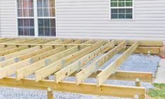 a wooden deck in front of a house