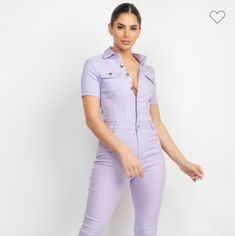 A Skinny Leg Jumpsuit Solid Color Basic Collar Short Sleeve Two Chest Flap Pockets Button Down And Zip Up Closure Cinched Waist Belt Loops Full-Length Jumpsuit Pockets 70% Rayon 25% Nylon And 5% Spandex Available In Ice Lavender Trendy Solid Color Jumpsuits And Rompers With Buttons, Fitted Short Sleeve Jumpsuit With Button Closure, Summer Purple Jumpsuits And Rompers For Work, Purple Jumpsuits And Rompers For Summer Workwear, Purple Summer Jumpsuits And Rompers For Work, Chic Lavender Jumpsuits And Rompers For Summer, Chic Fitted Jumpsuits And Rompers With Button Closure, Chic Fitted Jumpsuit With Button Closure, Trendy Short Sleeve Jumpsuits And Rompers With Buttons