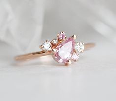 Declare your love with our lovely Armani ring, displaying a pink sapphire as a centerpiece, with beautiful clusters of white round diamonds acting as accents. Luxury Pink Sapphire Cluster Ring Gift, Rose Gold Pink Sapphire Ring For Wedding, Rose Gold Pink Sapphire Wedding Ring, Wedding Rose Gold Pink Sapphire Ring, Pink Cluster Promise Ring In Fine Jewelry Style, Pink Diamond Cluster Ring As A Gift, Pink Cluster Ring As Gift In Fine Jewelry Style, Pink Cluster Ring For Gift - Fine Jewelry, Pink Cluster Ring As A Gift