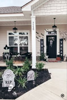 a house decorated for halloween with tombstones and decorations