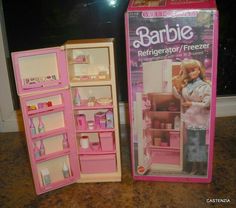 two barbie dolls are shown in their pink and white boxes, one is opened to reveal the contents