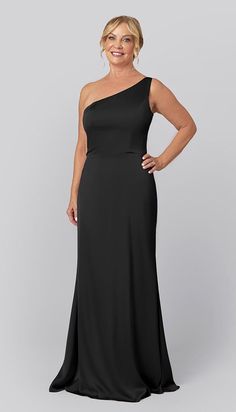 a woman in a black dress posing for the camera with her hands on her hips