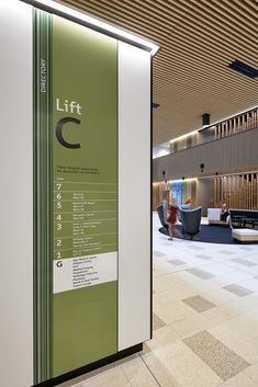 an airport lobby with seating and information on the wall