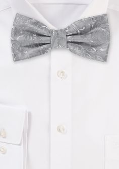 This Festive Silver Proper Paisley Bowtie will make everyone in your wedding party seem absolutely beautiful. The paisley design is woven into the fabric, which provides the tie with a smooth surface and allows it to shimmer when exposed to light. Combines splendidly with a black suit or tuxedo and a white shirt for an elegant look. Elegant Formal Ties With Paisley Print, Elegant Paisley Print Tie As A Gift, Elegant Paisley Print Ties As Gift, Wedding Ties With Paisley Print, Fitted Paisley Print Suit And Tie Accessories For Wedding, Elegant Wedding Ties With Paisley Print, Elegant Wedding Suit And Tie Accessories With Paisley Print, Wedding Paisley Print Standard Tie, Wedding Paisley Print Tie