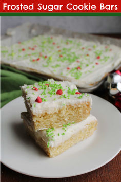 two pieces of frosted sugar cookie bars on a plate