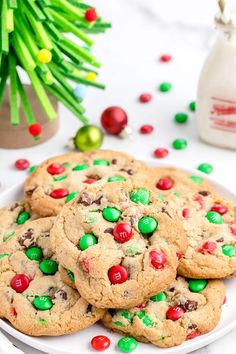 christmas cookies on a plate with candy beans and m & m's in the background