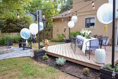 a dog is standing on the deck in front of an outdoor dining table and chairs