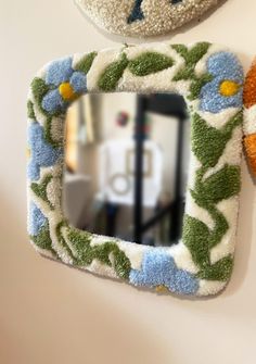 two teddy bears are hanging on the wall next to a mirror and stuffed animal toys