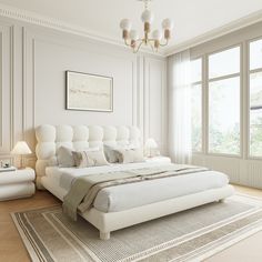 a large white bed sitting in the middle of a bedroom next to two lamps on either side of it