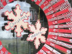 a red and white wreath with snowflakes hanging from it