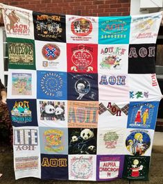 a woman standing next to a large quilt covered in different types of t - shirts