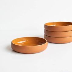 three brown bowls sitting on top of each other