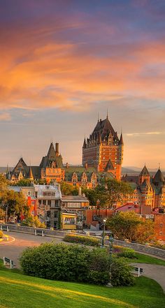 an image of a beautiful sunset in the city with old buildings and green lawns