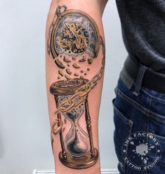 a man with a tattoo on his arm has a clock and hour glass in it